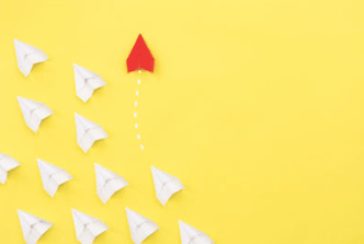Illustration of one red arrow leading multiple white arrows on yellow background