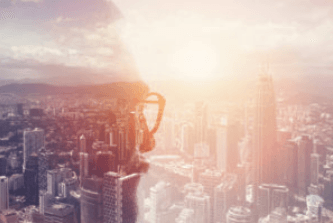 Security shield icon overlaid on cityscape at sunset