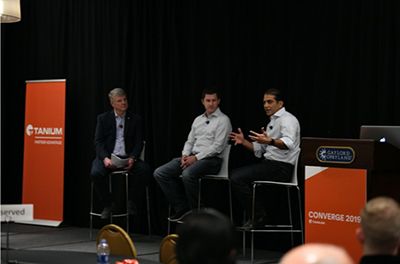 Three men speaking on stage at Converge 2025 conference