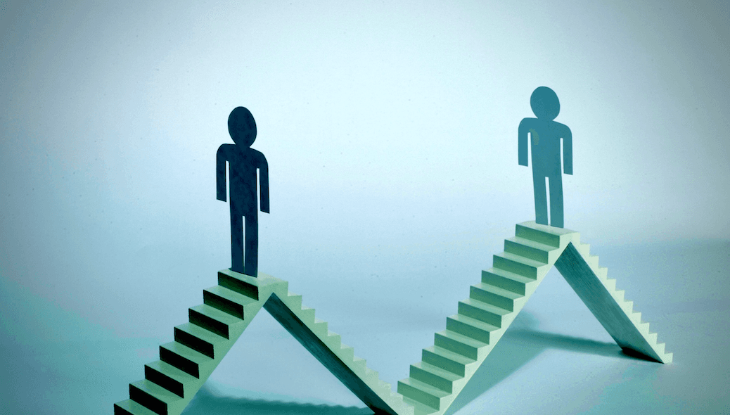 In a hazy green light, two paper men face each other atop two pyramids formed by staircases.