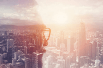 Security shield icon overlaid on cityscape at sunset