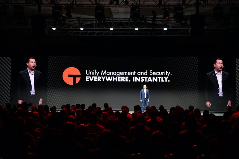 Two speakers in conversation on stage at CONVERGE 2019 Tanium conference