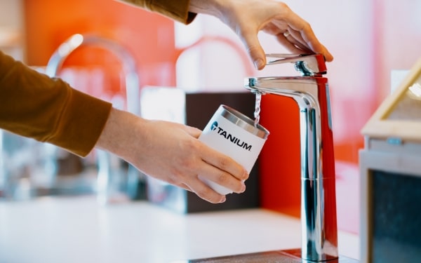 Drinking water poured into a white Tanium cup