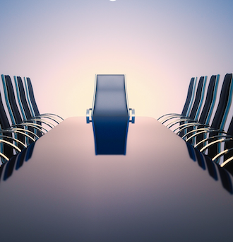 A long, black boardroom table buffed to a high-gloss finish and lined with chairs stretches into the distance, and a sunrise beyond.