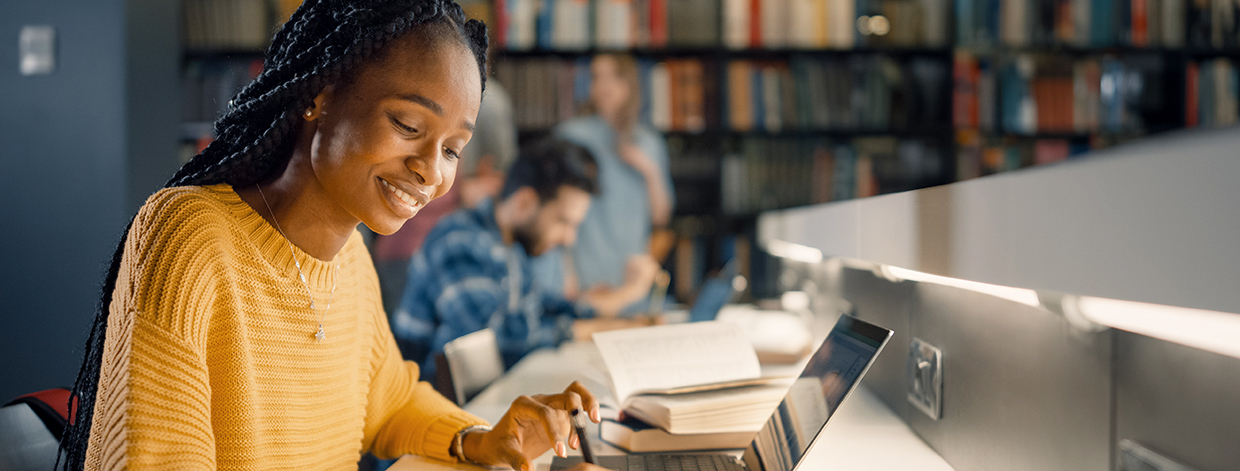 University Library: Gifted Black Girl uses Laptop, Writes Notes