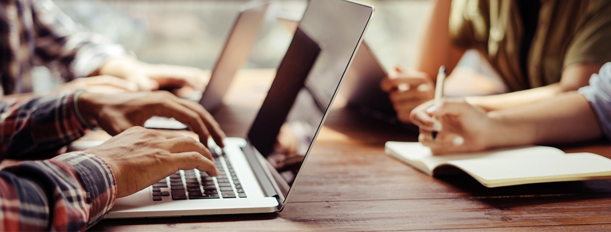 stock image. Multiple laptops being used on a desk