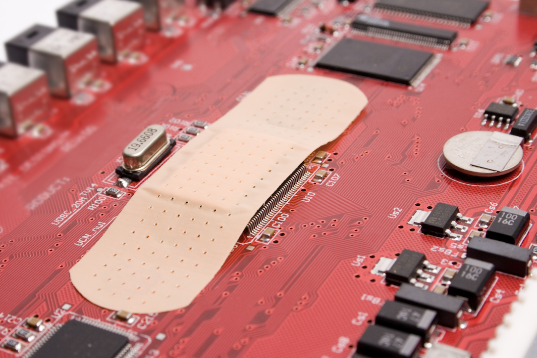 Image of a bandage on a motherboard that represents the necessity of patch management