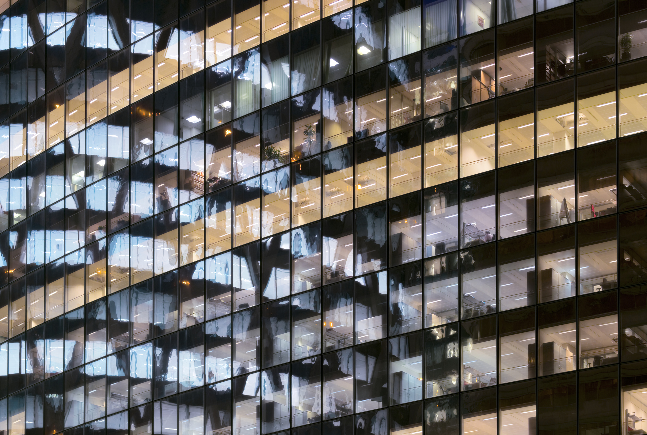 A photo of glass office towers, with row after row of windows reflected in other windows.