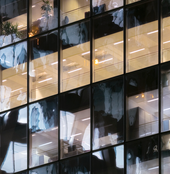 A photo of glass office towers, with row after row of windows reflected in other windows.
